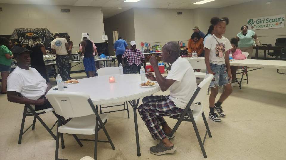 Neighbors sharing a meal together at a community gathering
