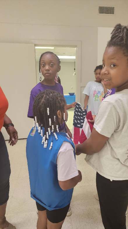 Girl Scouts participating in an indoor group activity