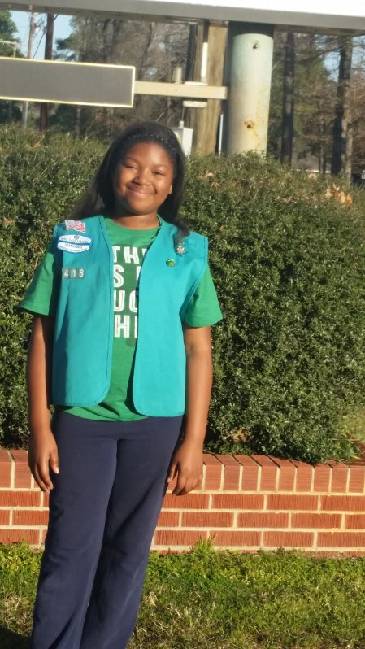 Girl Scout standing outdoors in uniform